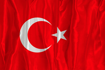 The flag of Turkey on a silk background is a great national symbol. Texture of fabrics The official state symbol of the country