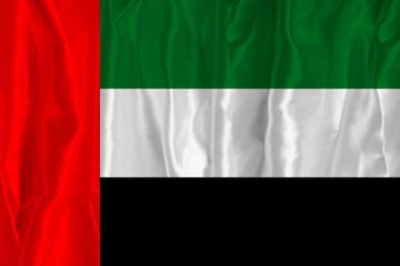 The flag of the United Arab Emirates on a silk background is a great national symbol. Texture of fabrics The official state symbol of the country