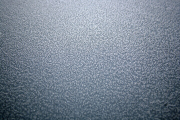 Top down Macro shot of Ice crystals on Car paint that looks like frozen carpet. Sharp in the center and soft focus around the outside.