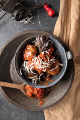 Black bean spaghetti pasta noodles, meatballs, red sauce, topped with fresh grated mozzarella cheese.