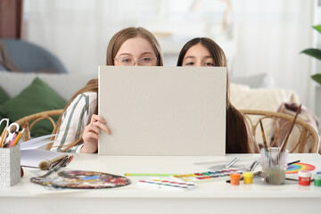 Drawing teacher and little girl with blank poster at home