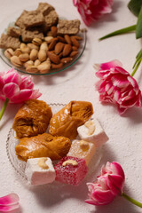Still life of Turkish Delight on a light background with pink tulips