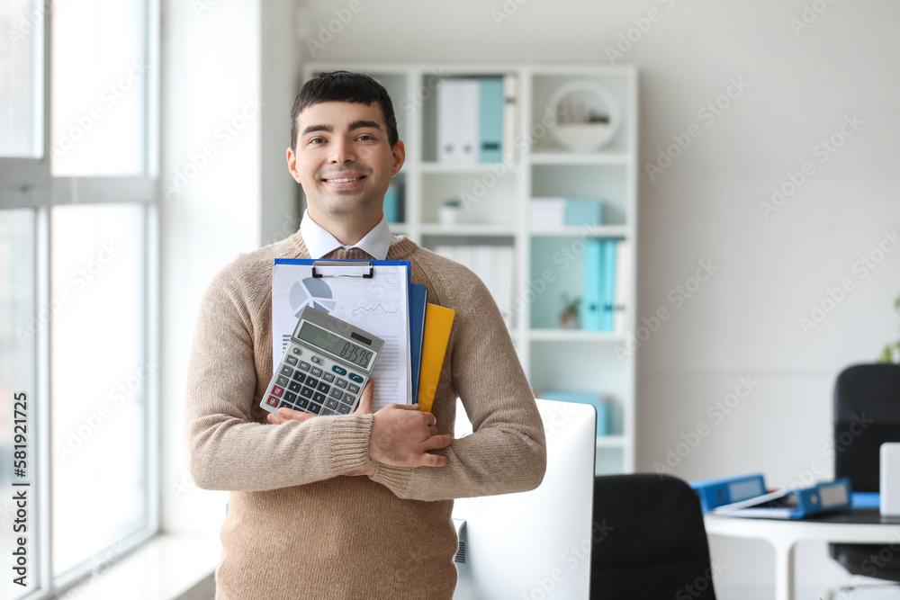 Wall mural Young accountant with documents and calculator in office