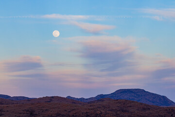 Sunset landscape with a full moon in Wichita Mountains National Wildlife Refuge