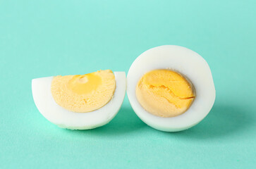 Delicious boiled eggs on turquoise background