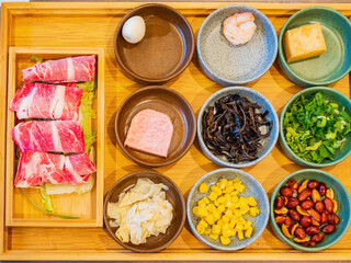 Close up shot of many ingredient for GuoQiao rice noodle