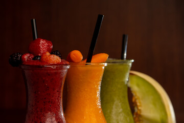 Juice bottles isolated on wooden background with a melon