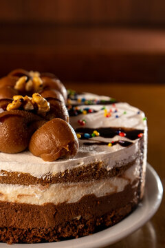 chocolate cake with white American cream. decorated with chocolates and chips: vertical image