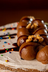 chocolate cake with white American cream. decorated with chocolates and chips: vertical image