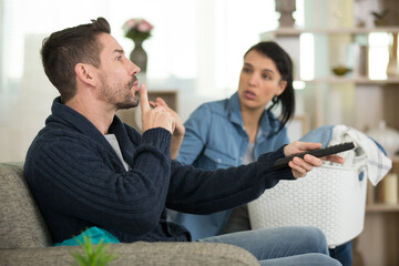 man telling woman to be quiet during tv programme