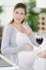 pregnant woman rejecting alcohol at home