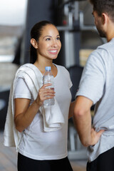 young couple at fitness training in fitness center - obrazy, fototapety, plakaty