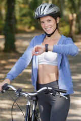 bicyclist girl looking at watch on smart watch