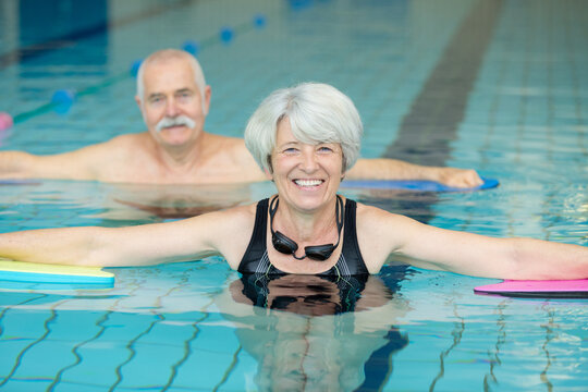 close up of elder couple doing exercises in the pool