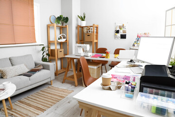 Interior of atelier with tailor's workplace and sofa