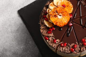 Slate board with delicious birds milk cake on light background, closeup