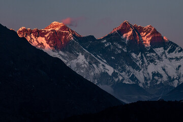 Pink sunset at Lhotse and Nuptse with marshmallow cloud over Mount Everest 