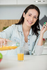 Fototapeta beautiful young woman with glass of orange juice obraz