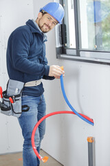 plumber working on pipework installation