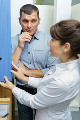 Obraz premium woman and man and wooden door workshop