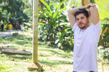 Fototapeta premium latino white man doing arm stretch
