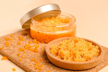 Cork mat with jar and plate of body scrub on color background, closeup