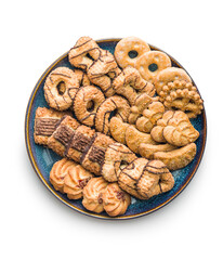 Assorted various cookies. Sweet biscuits on plate isolated on white background.