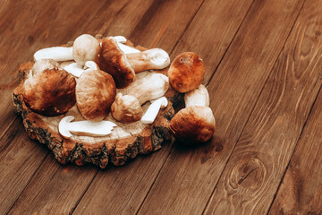 Boletus edulis on a table made of brown boards preparation for eating.