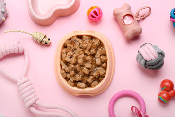 Composition with different pet care accessories and wet food on pink background