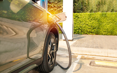 Suv EV electric car charging DC current into the vehicle battery socket fill the electric vehicle...