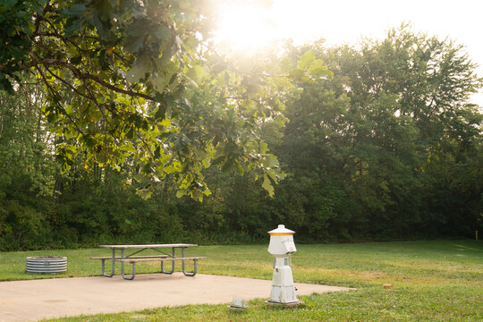 Empty Outdoor Campsite at a campground in Summer with a picnic table and firepit