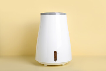 Modern humidifier on beige background