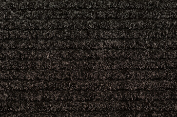 Fototapeta premium Black door carpet with horizontal stripes as background texture