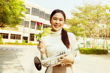 International music teacher in school : Portrait beautiful asian teacher healthy holding bright red...
