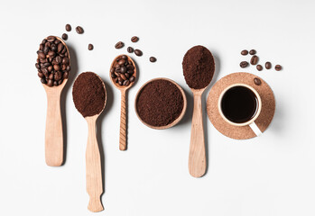 Spoons of coffee powder, beans and cup on white background