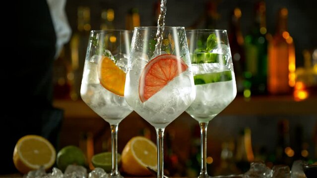 Super Slow Motion Shot of Pouring Gin and Tonic Into Long Glasses with Camera Motion at 1000fps.
