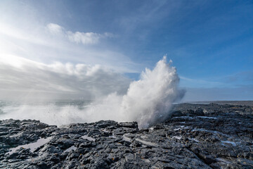 Fototapeta na wymiar Black rocks on the coast of Iceland with big waves
