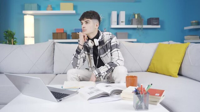 University student adaptation problem, lack of concentration.
Young man unable to concentrate while studying. Pensive and thoughtful.
