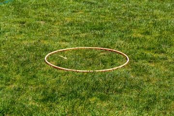 Hula hoops lying on the field © Natalia