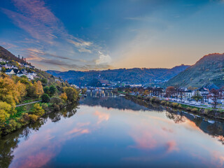 Cochem town on both sides of Moselle river after sunset during colourful autumn season in Cochem-Zell district, Germany
