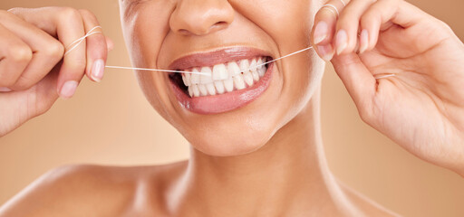 Flossing, smile and a woman with dental care for teeth isolated on a studio background. Happy,...