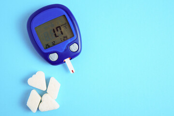 The meter is insulated on a blue background. Blood sugar measurements. The concept of diabetes....