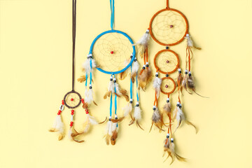 Beautiful dreamcatchers on beige background