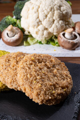 Uncooked fresh vegan and vegetarian burgers made from fresh vegetables and dried legumes and beans