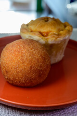 Traditional street food in UK, stuffed fried Scotch eggs with breadcrumbs and baked pie with pork meat