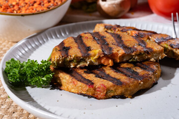Barbecue grilled tasty vegan and vegetarian burgers made from fresh vegetables and dried legumes and beans
