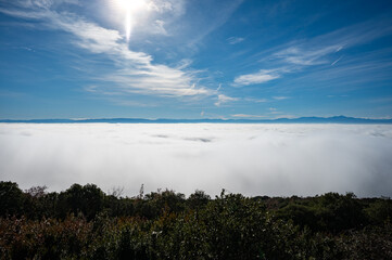 Sea of white clouds above Rioja Alavesa valley as seen from sunny point of view Balcon De La Rioja, Spain in winter