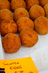 Traditional street food in UK, stuffed fried Scotch eggs with breadcrumbs