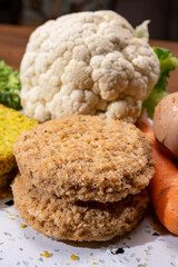 Uncooked fresh vegan and vegetarian burgers made from fresh vegetables and dried legumes and beans