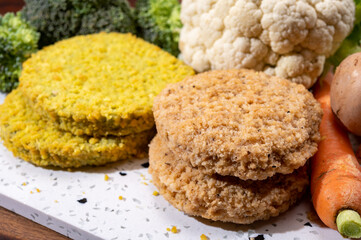 Uncooked fresh vegan and vegetarian burgers made from fresh vegetables and dried legumes and beans